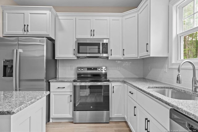 432 Timberline Dr, Fayetteville, NC 28311 - kitchen featuring appliances with stainless steel finishes, a sink, and white cabinetry