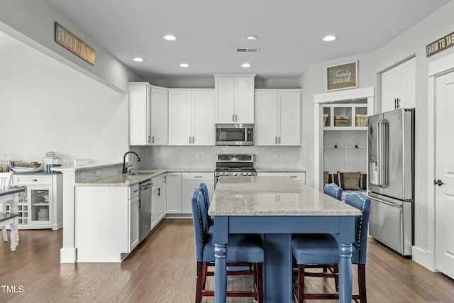 2801 Landon Ridge Dr, New Hill, NC 27562 - kitchen with visible vents, appliances with stainless steel finishes, white cabinetry, and a sink