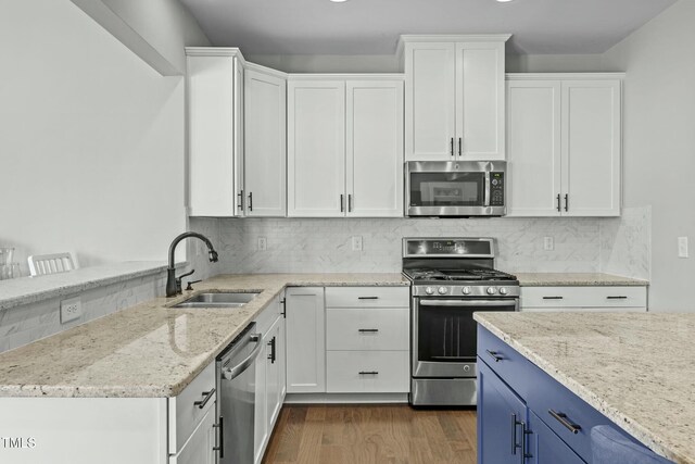 2801 Landon Ridge Dr, New Hill, NC 27562 - kitchen with a sink, dark wood-style floors, white cabinetry, and stainless steel appliances