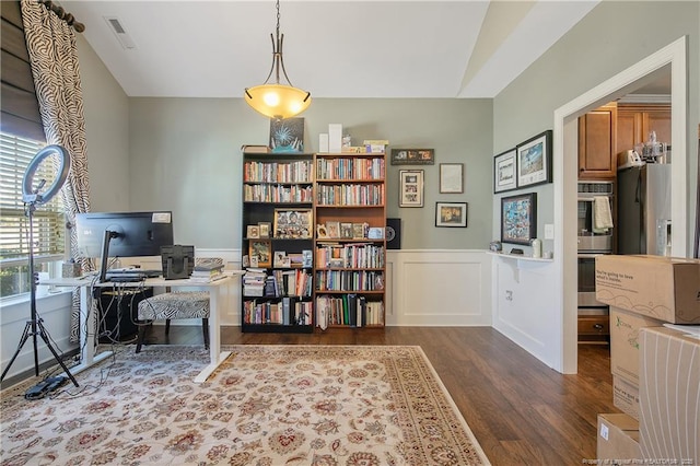 office space with wood finished floors and wainscoting