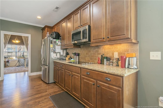kitchen with stainless steel appliances, tasteful backsplash, dark wood finished floors, light stone countertops, and baseboards