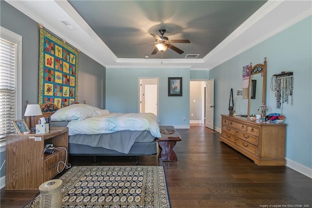 bedroom with a raised ceiling, hardwood / wood-style flooring, baseboards, crown molding, and ceiling fan