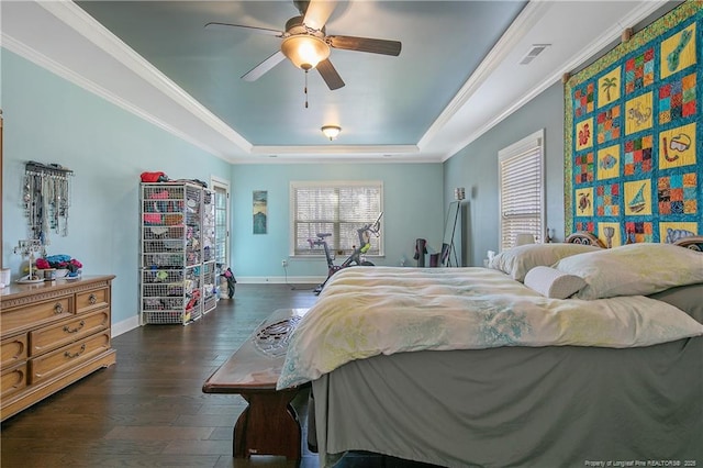 bedroom featuring a raised ceiling, dark wood-style flooring, baseboards, crown molding, and a ceiling fan