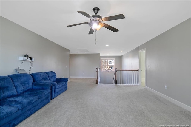 unfurnished living room featuring carpet floors, a chandelier, a ceiling fan, and baseboards