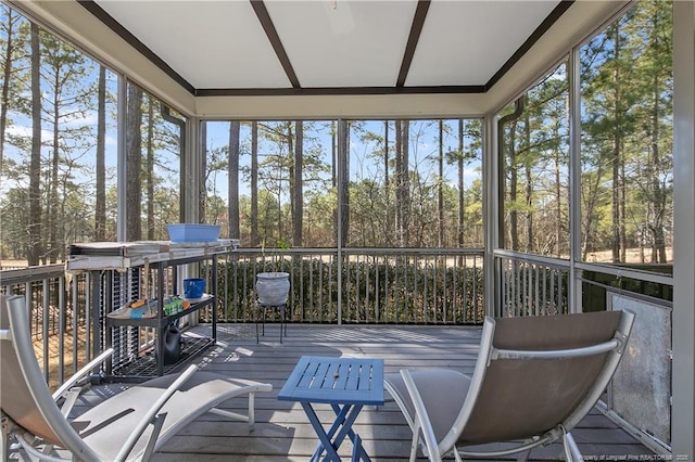 sunroom / solarium featuring healthy amount of natural light and view of scattered trees