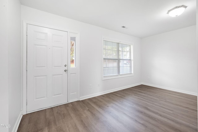 foyer entrance with baseboards and wood finished floors