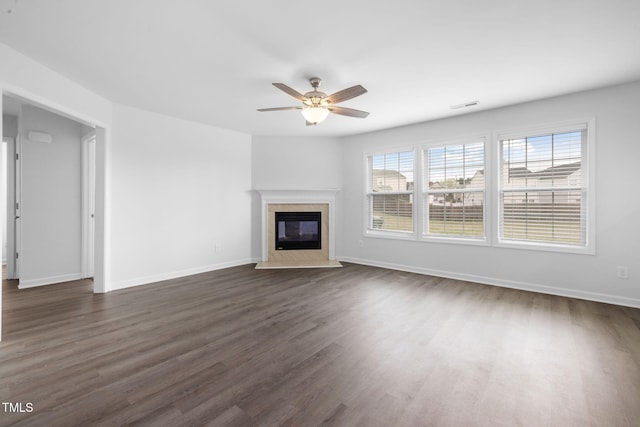 unfurnished living room featuring dark wood-style floors, visible vents, ceiling fan, and a fireplace