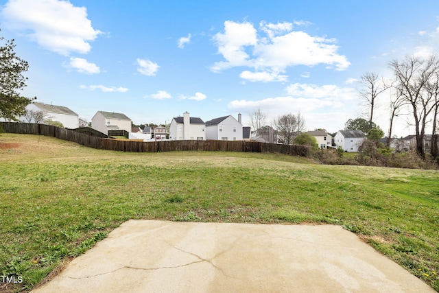 view of yard with a residential view and fence