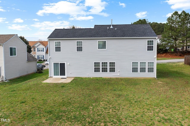 back of house with a yard and a patio area