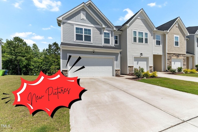 2137 Caen St, Raleigh, NC 27610 - view of front of property with stone siding, board and batten siding, concrete driveway, and a garage