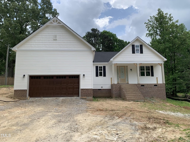view of front of home featuring dirt driveway, a shingled roof, a porch, and crawl space