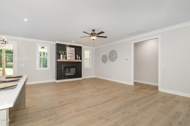 503 Forest Rd, Oxford, NC 27565 - unfurnished living room with plenty of natural light, light wood-style flooring, crown molding, a chandelier, and a fireplace