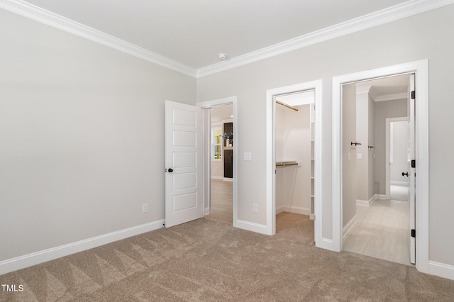 503 Forest Rd, Oxford, NC 27565 - unfurnished bedroom with ornamental molding, a walk in closet, carpet flooring, and a closet