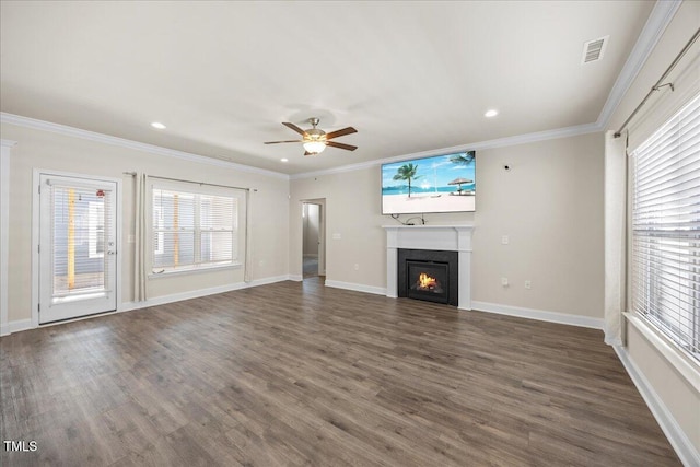unfurnished living room with a warm lit fireplace, a healthy amount of sunlight, and visible vents