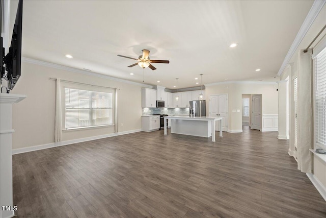 unfurnished living room with a ceiling fan, recessed lighting, and dark wood-type flooring