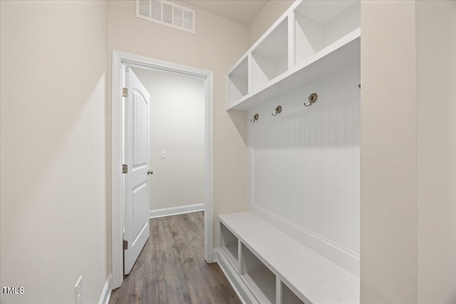 mudroom featuring baseboards, dark wood-type flooring, and visible vents