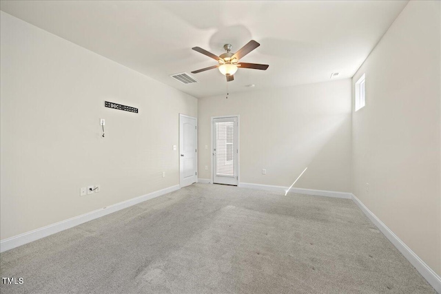 unfurnished room with visible vents, light carpet, baseboards, and ceiling fan