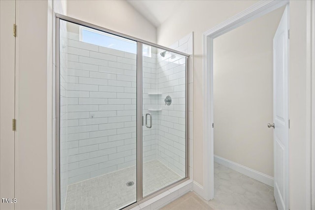 full bath featuring baseboards and a stall shower