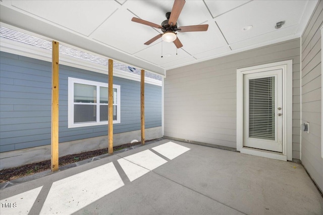 unfurnished sunroom with a ceiling fan
