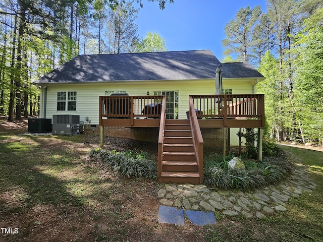 4116 Tall Pine Dr, Franklinton, NC 27525 - back of property with stairway, central air condition unit, a deck, and a shingled roof