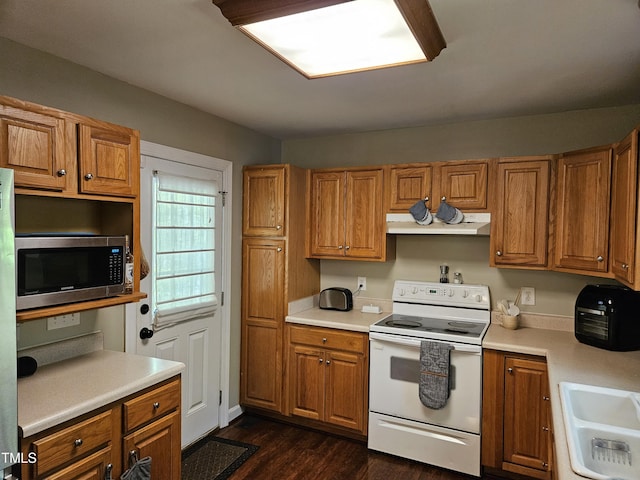 4116 Tall Pine Dr, Franklinton, NC 27525 - kitchen with white range with electric cooktop, stainless steel microwave, a sink, and brown cabinetry
