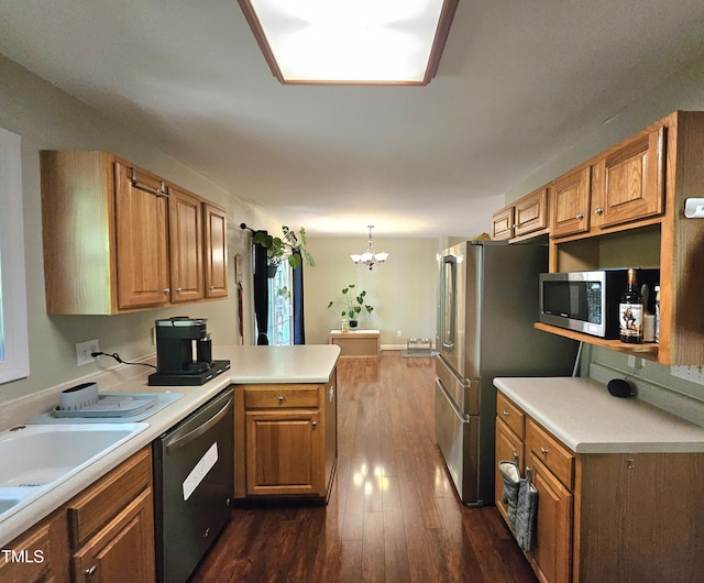 4116 Tall Pine Dr, Franklinton, NC 27525 - kitchen featuring appliances with stainless steel finishes, a peninsula, a chandelier, dark wood-type flooring, and light countertops