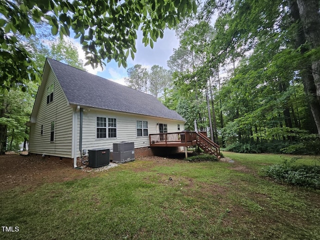 4116 Tall Pine Dr, Franklinton, NC 27525 - back of house featuring central AC, roof with shingles, a wooden deck, and a lawn