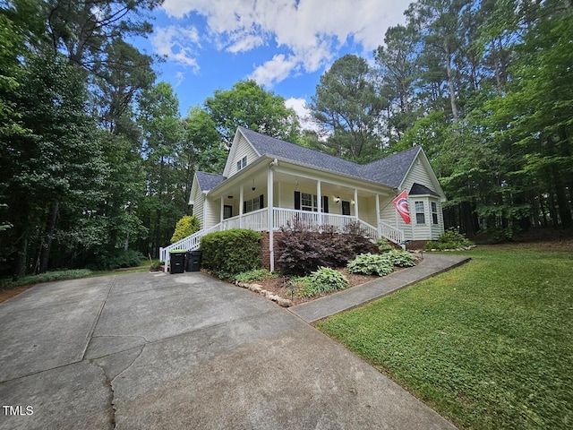4116 Tall Pine Dr, Franklinton, NC 27525 - view of property exterior with a porch, a yard, and roof with shingles