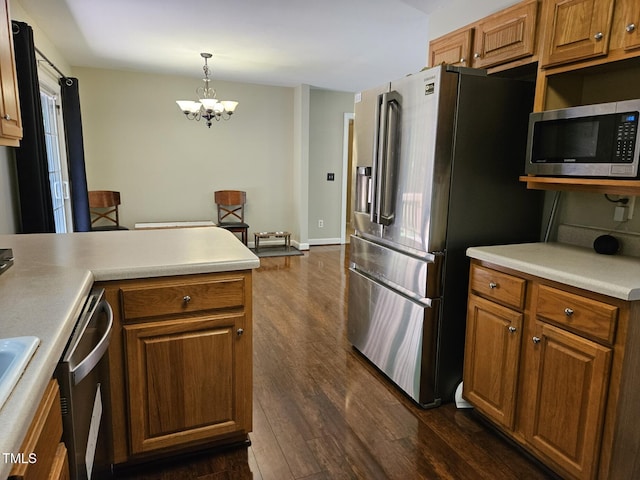 4116 Tall Pine Dr, Franklinton, NC 27525 - kitchen featuring stainless steel appliances, dark wood finished floors, a chandelier, and brown cabinetry