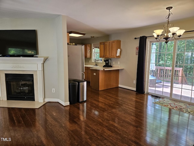 4116 Tall Pine Dr, Franklinton, NC 27525 - kitchen featuring freestanding refrigerator, dark wood-type flooring, light countertops, a chandelier, and a peninsula