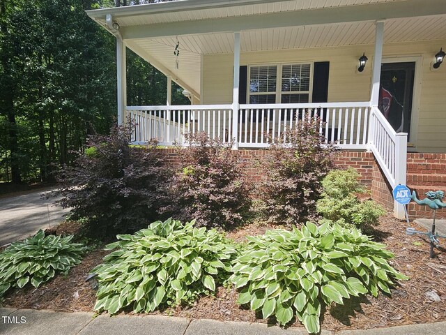 4116 Tall Pine Dr, Franklinton, NC 27525 - property entrance with a porch and brick siding