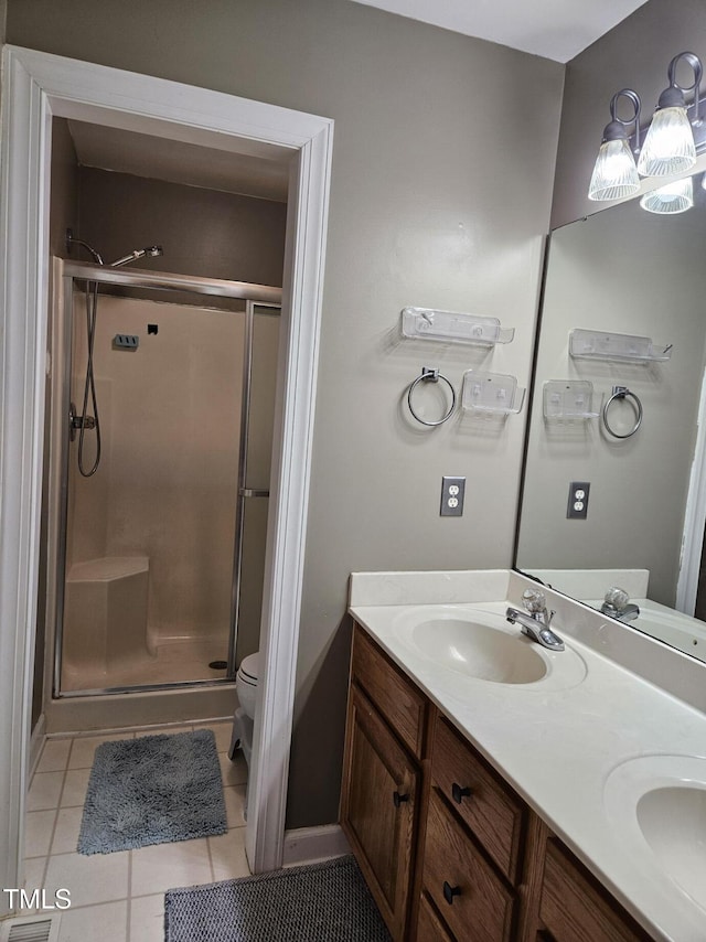 4116 Tall Pine Dr, Franklinton, NC 27525 - bathroom with a shower stall, tile patterned flooring, double vanity, and toilet