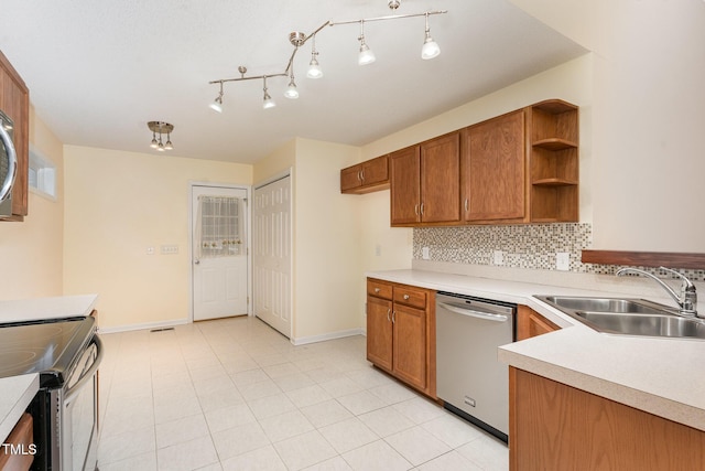 1603 Stonegate S, Sanford, NC 27332 - kitchen with decorative backsplash, a sink, brown cabinetry, and appliances with stainless steel finishes