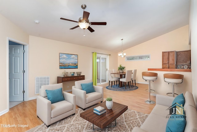 1603 Stonegate S, Sanford, NC 27332 - living room with lofted ceiling, light wood-type flooring, ceiling fan with notable chandelier, baseboards, and visible vents