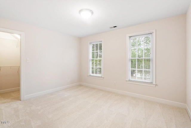 carpeted spare room featuring baseboards