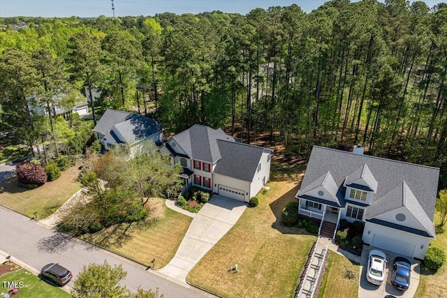 view from above of property with a heavily wooded area