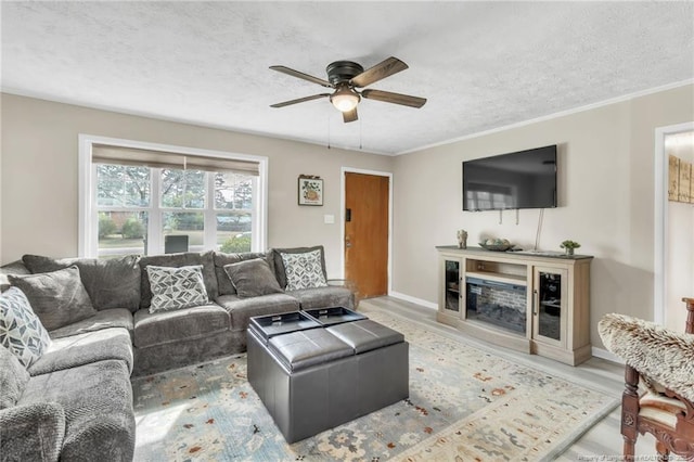 1002 Hicks Ave, Fayetteville, NC 28304 - living room with a textured ceiling, wood finished floors, a ceiling fan, and ornamental molding