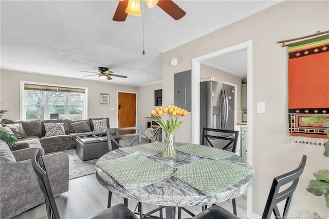 1002 Hicks Ave, Fayetteville, NC 28304 - dining room featuring wood finished floors, crown molding, a textured ceiling, and ceiling fan