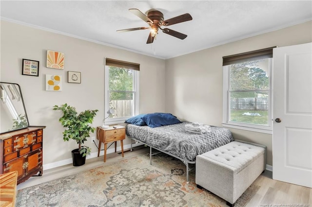 1002 Hicks Ave, Fayetteville, NC 28304 - bedroom with baseboards, ceiling fan, wood finished floors, and crown molding
