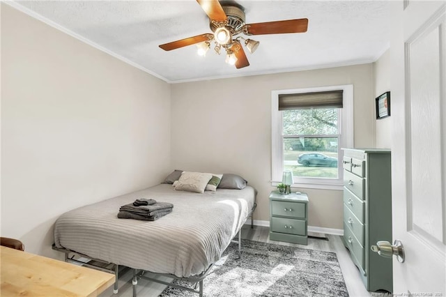 1002 Hicks Ave, Fayetteville, NC 28304 - bedroom with a ceiling fan, ornamental molding, baseboards, and wood finished floors