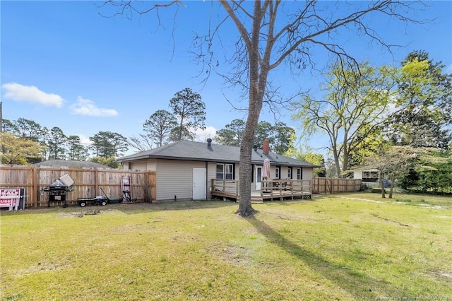 1002 Hicks Ave, Fayetteville, NC 28304 - back of house featuring fence, a lawn, a chimney, and a deck
