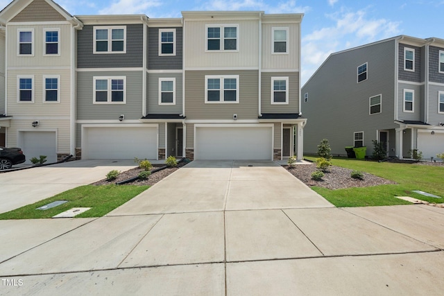 3025 Castle Loch Ln, Durham, NC 27703 - townhome / multi-family property with an attached garage, concrete driveway, and stone siding