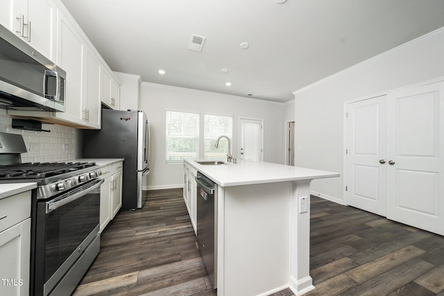 3025 Castle Loch Ln, Durham, NC 27703 - kitchen with appliances with stainless steel finishes, a sink, ornamental molding, dark wood-type flooring, and baseboards