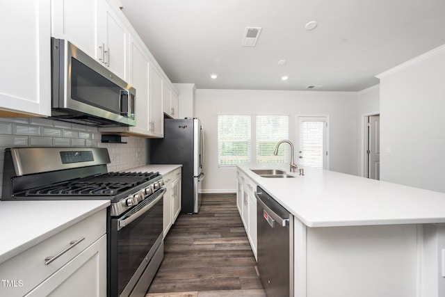 3025 Castle Loch Ln, Durham, NC 27703 - kitchen with appliances with stainless steel finishes, a sink, crown molding, dark wood finished floors, and a kitchen island with sink