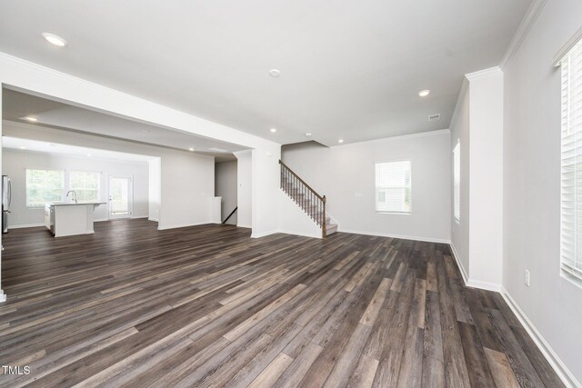 3025 Castle Loch Ln, Durham, NC 27703 - unfurnished living room with dark wood-style floors, stairway, a sink, baseboards, and recessed lighting