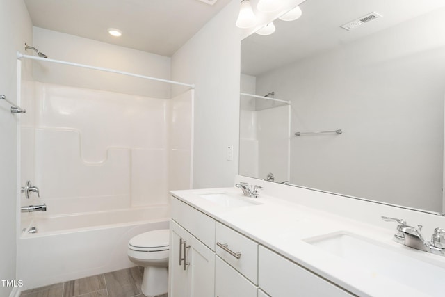3025 Castle Loch Ln, Durham, NC 27703 - bathroom featuring double vanity, washtub / shower combination, toilet, and recessed lighting