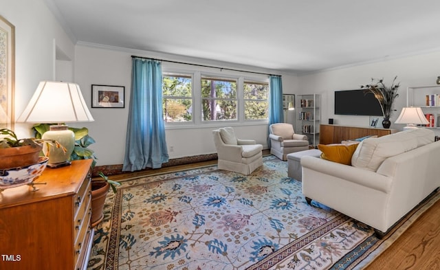living area featuring crown molding and wood finished floors