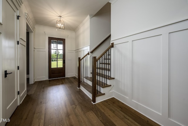 8620 Dukes Lake Rd, Zebulon, NC 27597 - entrance foyer with a decorative wall, a chandelier, stairway, dark wood-style floors, and a wainscoted wall