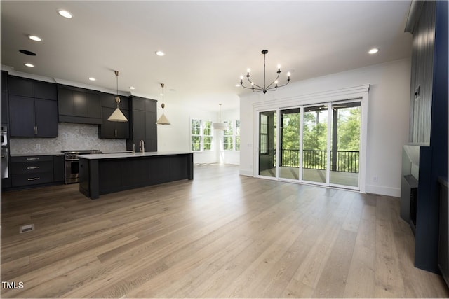 8620 Dukes Lake Rd, Zebulon, NC 27597 - kitchen with high end stainless steel range oven, a chandelier, tasteful backsplash, open floor plan, and light countertops