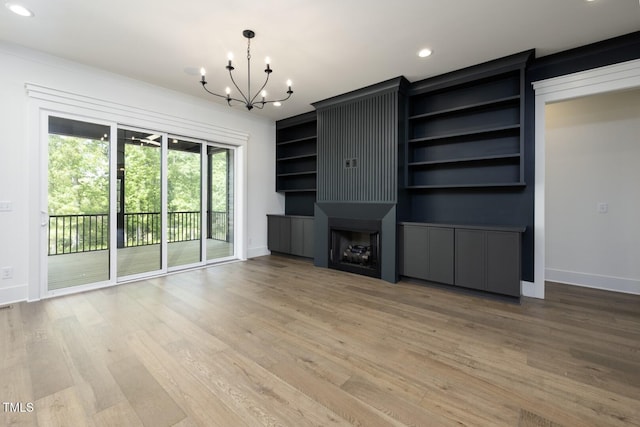8620 Dukes Lake Rd, Zebulon, NC 27597 - unfurnished living room with a chandelier, light wood finished floors, and recessed lighting